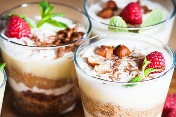 Dessert with berries, jelly, cream, nuts and mint leaf 