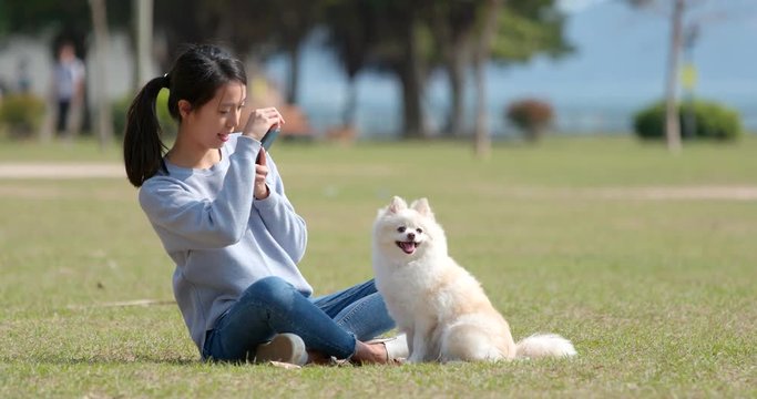 Woman taking photo with her dog