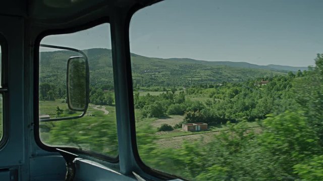 A on board shot of a train passing through some woods.