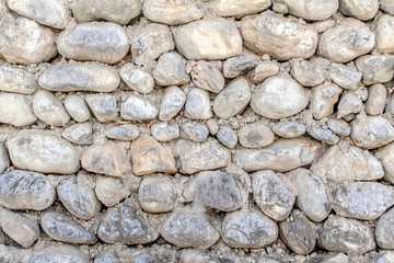 Stone fence of boulders as background