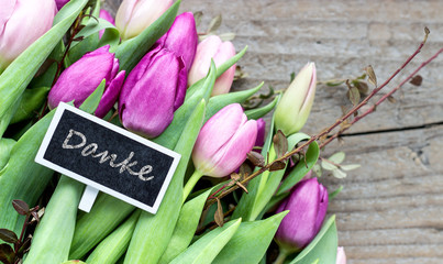 Thank you / bouquet with pink and violet tulips and card with german text: Thank you