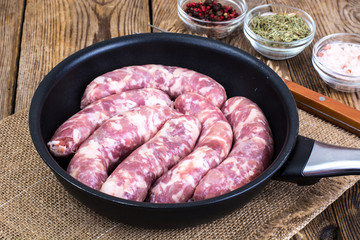 Sausage raw rustic in the pan