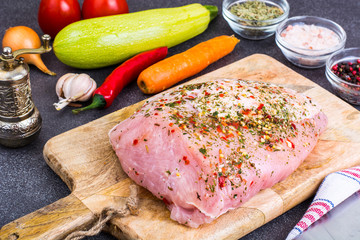 Piece of turkey fillet, marinated in spices, fresh vegetables for cooking
