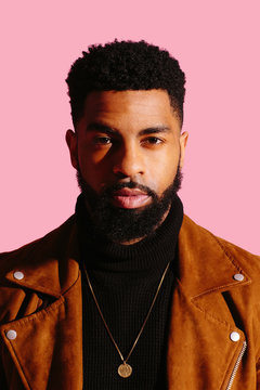 Portrait of a handsome man with beard a isolated on pink studio background
