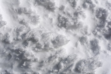 background, texture - bumpy white surface of mountain firn (hard caked snow)