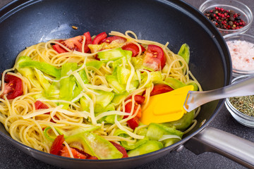Boiled spaghetti with vegetables and cheese