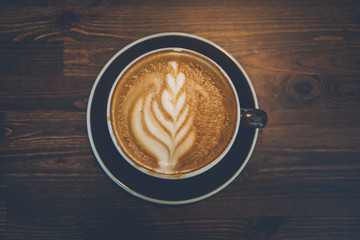 A cup of coffee on wooden surface