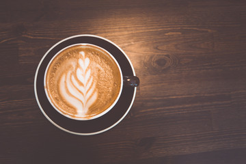 A cup of coffee on wooden surface