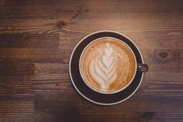 A cup of coffee on wooden surface