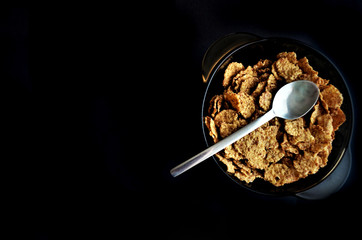 Corn flakes in a plate. Breakfast from flakes with honey and milk. Fast breakfast with corn flakes