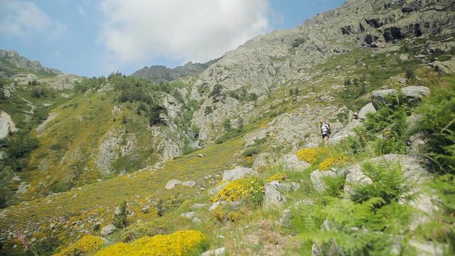 Teamwork concept. Young couple on trekking trip in Corsica, GR20 trail, France.