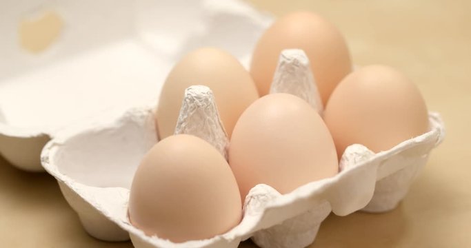 Picking one egg from paper pack