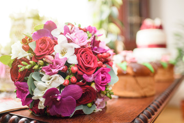 Beautiful colorful wedding bouquet on a wooden table
