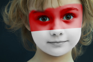 Child with a painted flag of Indonesia