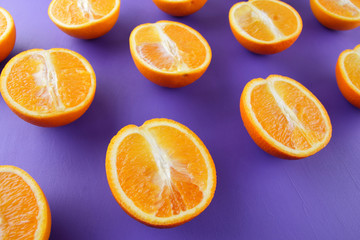 Sliced fruit oranges in checkered pattern on a purple background, symmetrically laid out citrus in pop art style, fruit pattern of halves of oranges, ultraviolet, minimalism, art