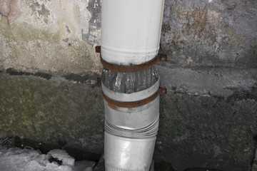 Damaged ice downpipe symbol poverty and decay
