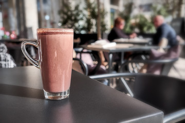 Hot chocolate cup in street cafe