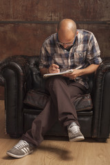 portrait of a young bald man with a beard and glasses