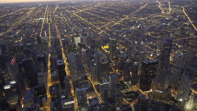 Chicago aerial view flying over Madison Street looking down on to Trump Tower and the Chicago River, moving towards Willis Tower at dusk