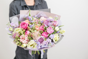 beautiful luxury bouquet of mixed flowers in woman hand. the work of the florist at a flower shop. A small family business