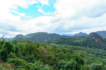 Fototapeta na wymiar panorama landscape view of jungle and mountain with blue sky and cloud in sunny day at thailand national park. nature or abstract background.