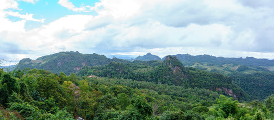 panorama landscape view of jungle and mountain with blue sky and cloud in sunny day at thailand national park. nature or abstract background.