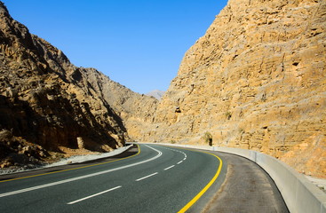 Fototapeta premium Empty mountain road through the dessert mountain on Jabal Jais