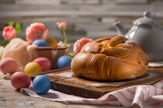 Easter folar with egg on wooden table top.