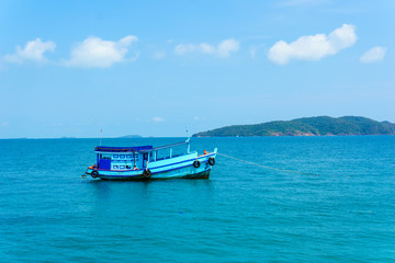 landscape view of seascape and skyline in the ocean with fishing boat and island.