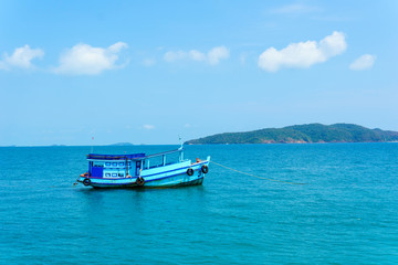 landscape view of seascape and skyline in the ocean with fishing boat and island.