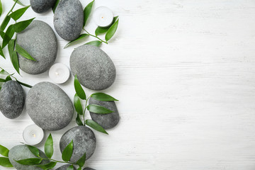 Spa stones and leaves on wooden background