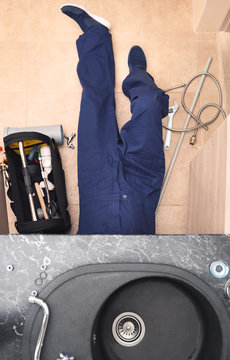 Professional male plumber repairing sink pipes indoors