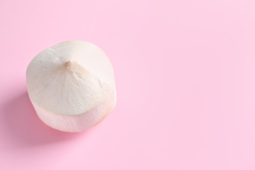 Fresh peeled coconut on color background
