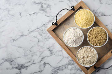 Composition with different types of flour on marble background