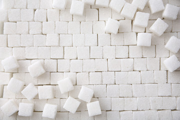 Refined sugar cubes as background, top view