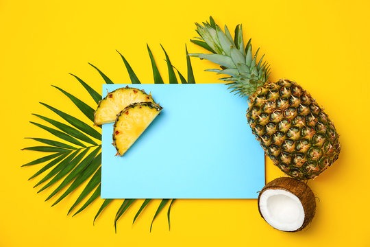 Fresh pineapples and coconut on color background, flat lay