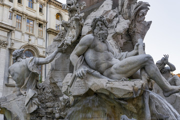 Rome, Italy Fontana dei Quattro Fiumi at Piazza Navona. Day view of 17th-century Fiumi Fountain at Navona square, designed in 1651 by Gian Lorenzo Bernini , showing the river-god Ganges.