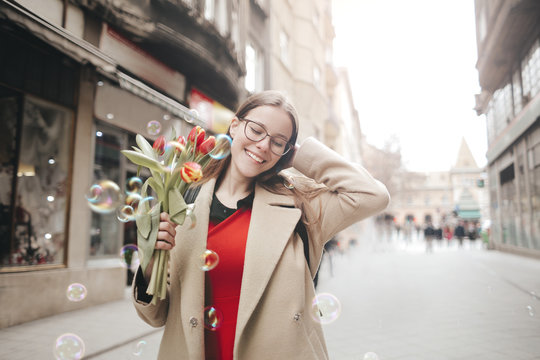 Beautiful girl holding a bouquet of flowers