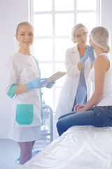 Fototapeta premium Beautiful woman face near doctor with syringe