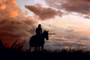 Thunder: atmospheric background of equine and girls silhouette on colorful storm clouds before a...