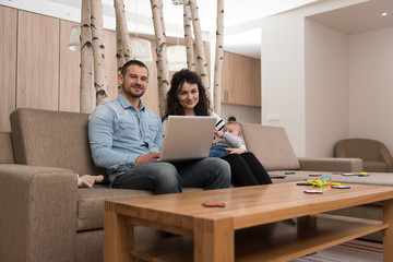 Portrait of Young Family Using Laptop Computer