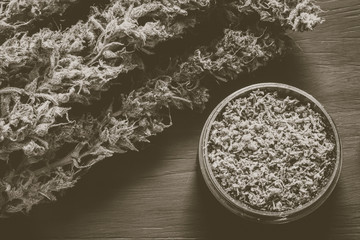 Macro of marijuana with trichomes and crushed weed in a grinder Vintage color