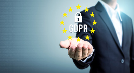 Businessman hand holding sign general data protection regulation (GDPR) and key icon