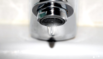 Image of droplet from faucet. water saving and Hydration concept