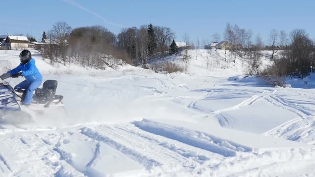 Man on snowmobile in winter mountain