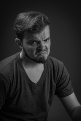Obraz premium Angry, frustrated and unhappy young Caucasian man