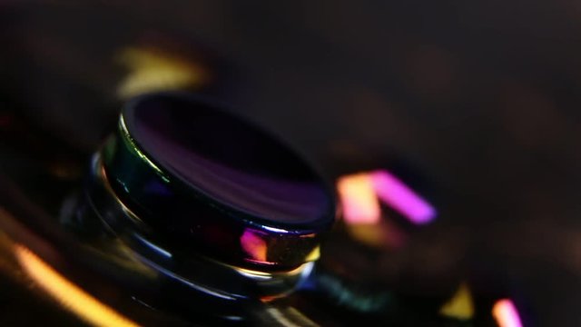 A spinning fast colorful fidget spinner macro close up
