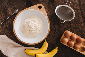 The ingredients for the banana cake flour egg on wooden table.