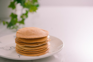 Cooking for breakfast. Delicious homemade pancakes on a plate