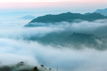 Top of the mountain in the morning with mist and sunrise.